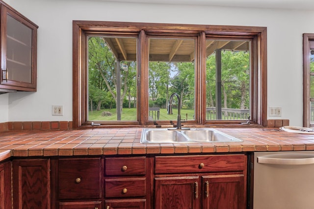 1054 Highland Dr, Columbus, OH 43220 - kitchen with dishwasher, healthy amount of natural light, glass insert cabinets, and tile countertops