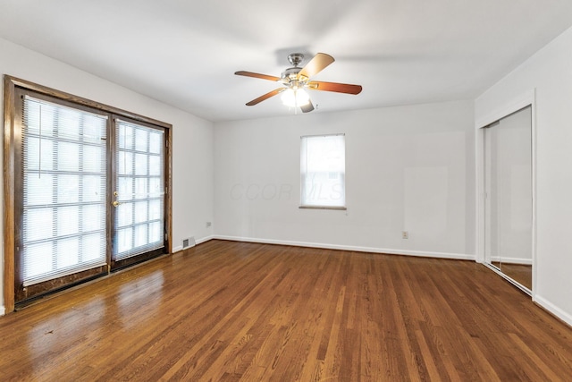 1054 Highland Dr, Columbus, OH 43220 - unfurnished bedroom with multiple windows, wood finished floors, a closet, and a ceiling fan