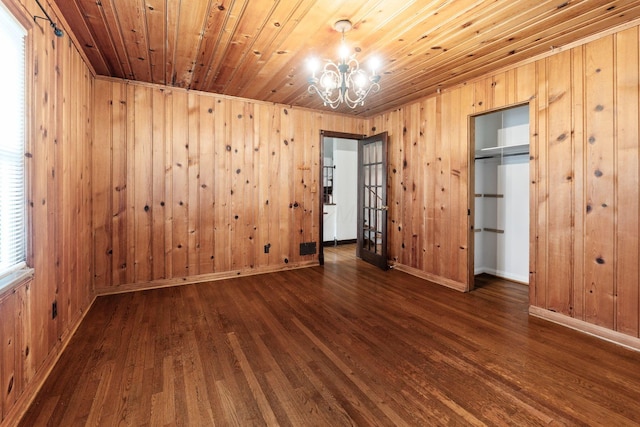 1054 Highland Dr, Columbus, OH 43220 - unfurnished bedroom with a chandelier, wood finished floors, wooden walls, a closet, and wood ceiling