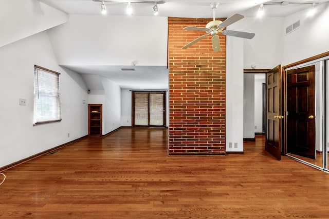 1054 Highland Dr, Columbus, OH 43220 - unfurnished living room with high vaulted ceiling, ceiling fan, rail lighting, and wood finished floors