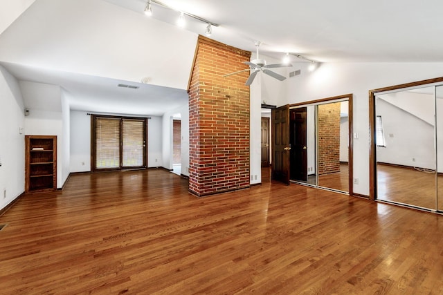 1054 Highland Dr, Columbus, OH 43220 - unfurnished living room with rail lighting, ceiling fan, wood finished floors, and high vaulted ceiling