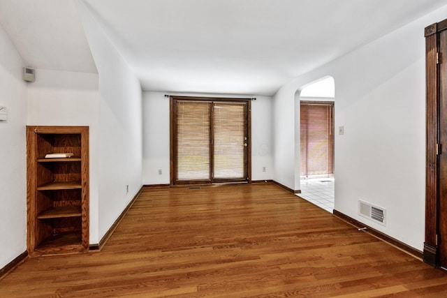 1054 Highland Dr, Columbus, OH 43220 - unfurnished room with arched walkways and wood finished floors