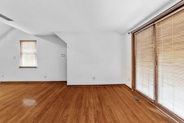 1054 Highland Dr, Columbus, OH 43220 - unfurnished bedroom with lofted ceiling and light wood-type flooring