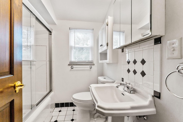 1054 Highland Dr, Columbus, OH 43220 - full bath with shower / bath combination with glass door and tile patterned floors