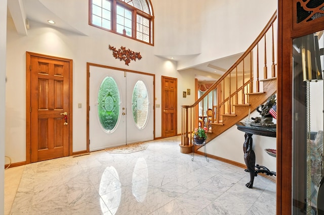 1515 Oak Run Ct, Mansfield, OH 44906 - foyer with light marble finish floors, stairs, french doors, and a towering ceiling