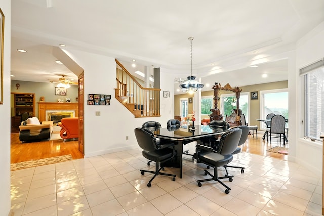 1515 Oak Run Ct, Mansfield, OH 44906 - dining room with light tile patterned floors, ceiling fan, a fireplace, stairs, and recessed lighting