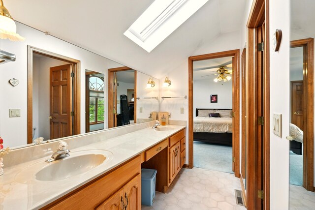 1515 Oak Run Ct, Mansfield, OH 44906 - ensuite bathroom featuring double vanity, vaulted ceiling, a skylight, tile patterned flooring, and a ceiling fan
