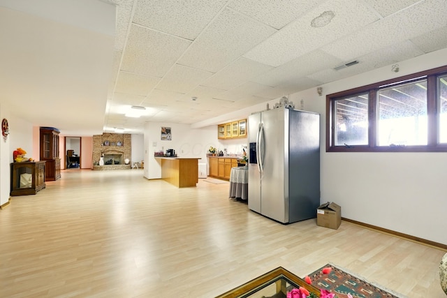1515 Oak Run Ct, Mansfield, OH 44906 - kitchen featuring stainless steel fridge with ice dispenser, open floor plan, light wood-style floors, glass insert cabinets, and light countertops