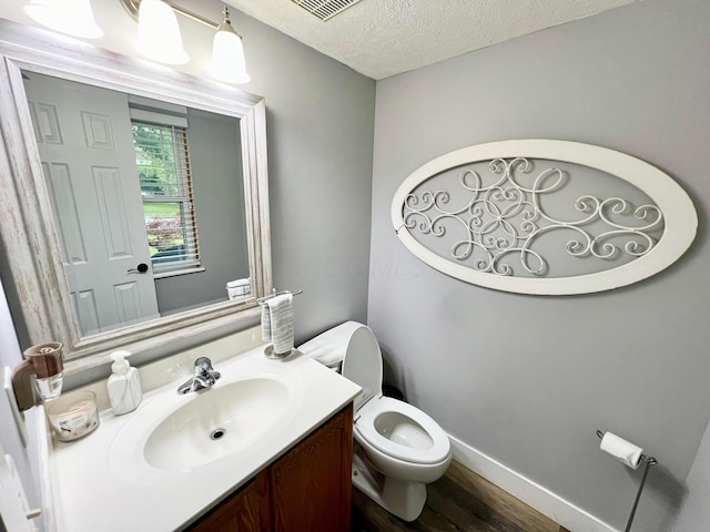 6871 Manor Crest Ln, Canal Winchester, OH 43110 - half bath featuring vanity, wood finished floors, and a textured ceiling