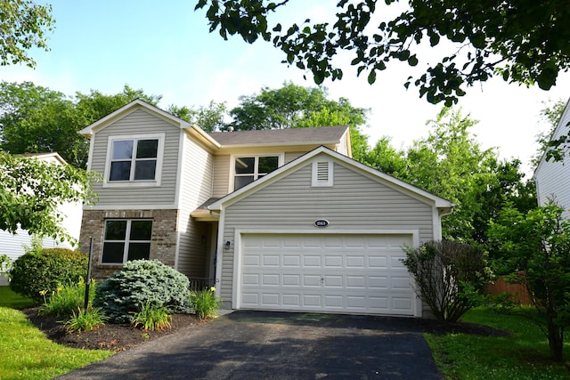 3565 Motts Place Ct, Canal Winchester, OH 43110 - view of front of house with driveway, an attached garage, and brick siding