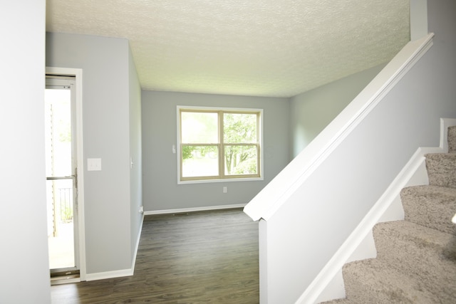 3565 Motts Place Ct, Canal Winchester, OH 43110 - stairs featuring wood finished floors and a textured ceiling
