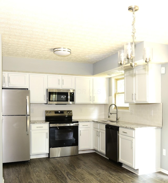 3565 Motts Place Ct, Canal Winchester, OH 43110 - kitchen featuring stainless steel appliances, a chandelier, white cabinetry, decorative backsplash, and a textured ceiling