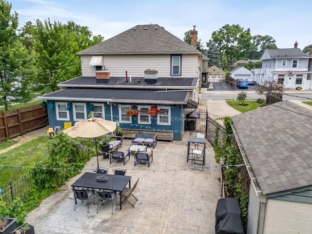 1484 Glenn Ave, Columbus, OH 43212 - back of house with a patio, a fenced backyard, an outdoor living space, a shingled roof, and a chimney