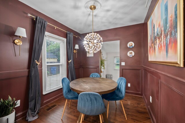 1484 Glenn Ave, Columbus, OH 43212 - dining room with a decorative wall, dark wood-type flooring, and a chandelier