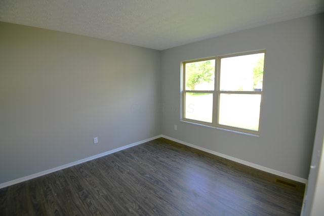 3434 Royal Hill Dr, Columbus, OH 43223 - empty room with dark wood-type flooring and a textured ceiling