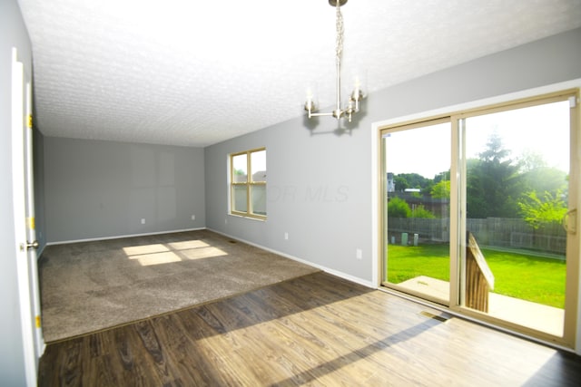 3434 Royal Hill Dr, Columbus, OH 43223 - empty room featuring a textured ceiling, a chandelier, and wood finished floors