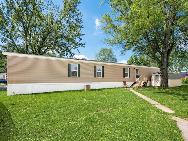 10610 E State Route 762 Unit 74B, Lockbourne, OH 43137 - back of house with a storage shed and a lawn