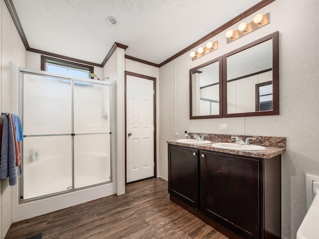 10610 E State Route 762 Unit 74B, Lockbourne, OH 43137 - bathroom with ornamental molding, wood finished floors, double vanity, and a stall shower