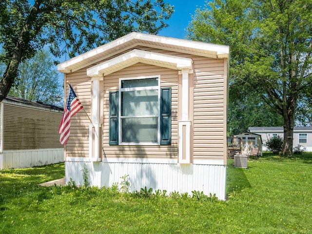 10610 E State Route 762 Unit 74B, Lockbourne, OH 43137 - view of property exterior featuring a yard
