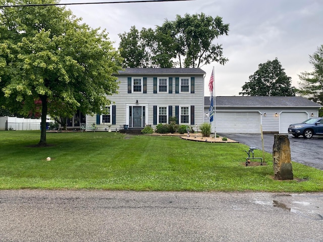537 Dunkle Rd, Circleville, OH 43113 - colonial-style house featuring driveway, a front lawn, and a garage
