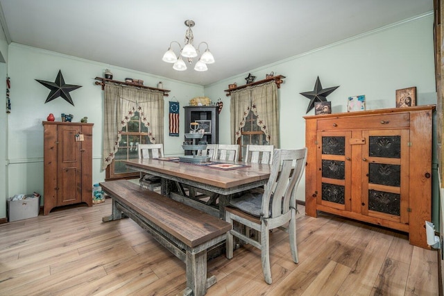 537 Dunkle Rd, Circleville, OH 43113 - dining space with a chandelier, ornamental molding, and light wood-style flooring