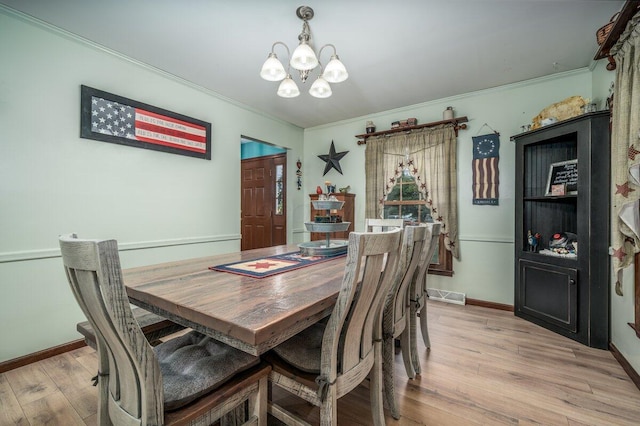 537 Dunkle Rd, Circleville, OH 43113 - dining room with a chandelier, light wood-style floors, and ornamental molding