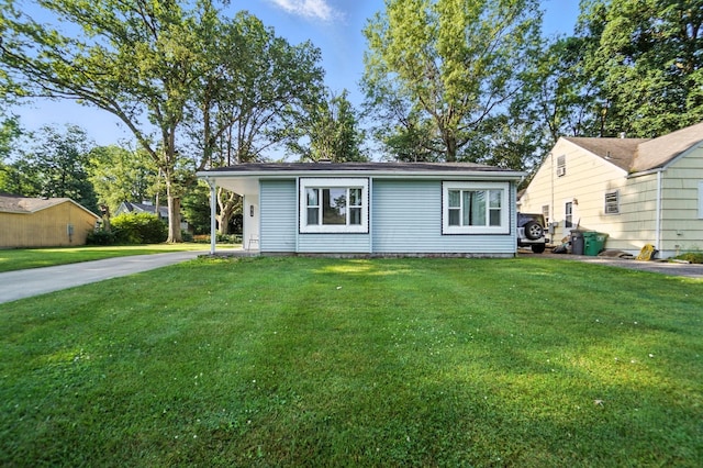 1919 Oakland Pkwy, Lima, OH 45805 - view of front of house featuring concrete driveway, a front yard, and a carport