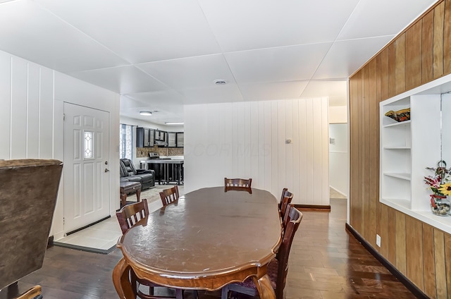 1919 Oakland Pkwy, Lima, OH 45805 - dining area featuring wood walls, dark wood-type flooring, and built in features