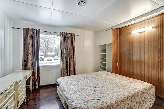 1919 Oakland Pkwy, Lima, OH 45805 - bedroom featuring dark wood-type flooring and wooden walls