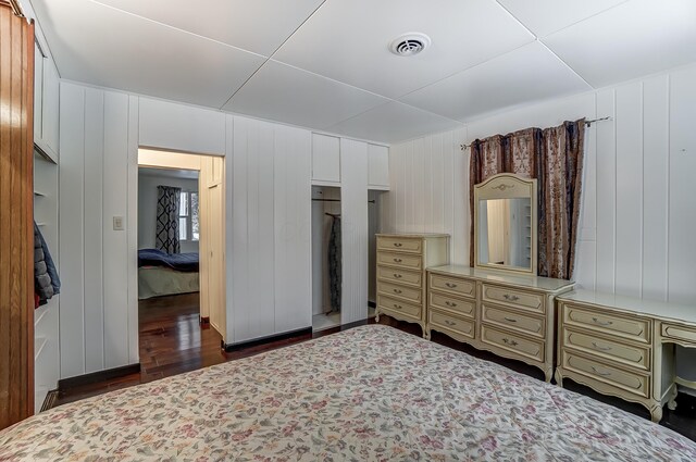 1919 Oakland Pkwy, Lima, OH 45805 - bedroom featuring dark wood-type flooring and a decorative wall