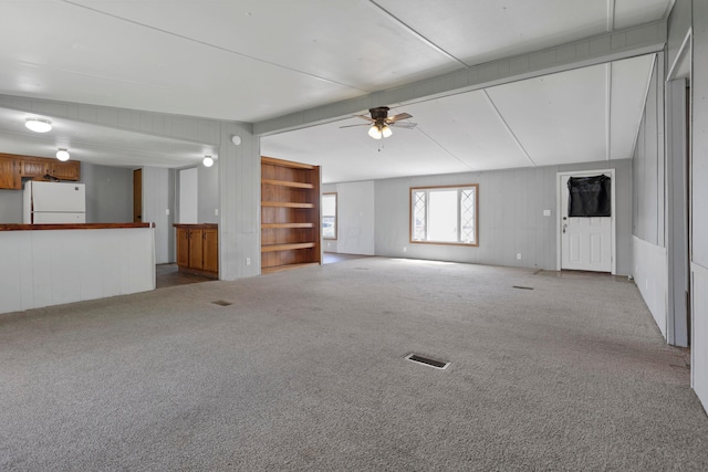 264 Timberline Dr, Circleville, OH 43113 - unfurnished living room featuring a ceiling fan, carpet floors, and beamed ceiling