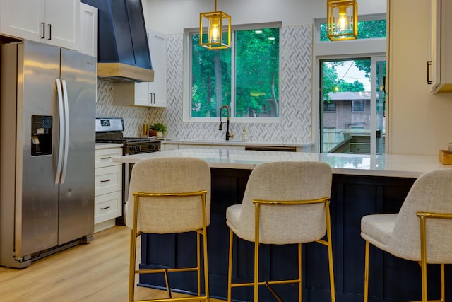 1017 Madison Ave, Columbus, OH 43205 - kitchen featuring appliances with stainless steel finishes, custom exhaust hood, white cabinets, and light wood-type flooring