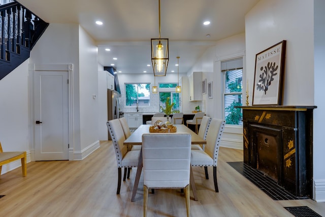 1017 Madison Ave, Columbus, OH 43205 - dining space featuring light wood finished floors, a fireplace, and recessed lighting