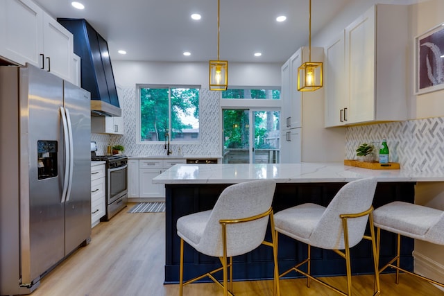 1017 Madison Ave, Columbus, OH 43205 - kitchen with stainless steel appliances, light stone counters, a peninsula, decorative backsplash, and recessed lighting