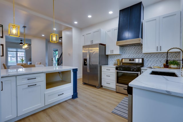 1017 Madison Ave, Columbus, OH 43205 - kitchen featuring stainless steel appliances, backsplash, light wood-style flooring, ceiling fan, and pendant lighting