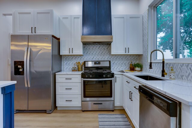 1017 Madison Ave, Columbus, OH 43205 - kitchen with stainless steel appliances, range hood, backsplash, and white cabinets