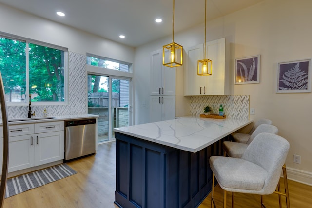1017 Madison Ave, Columbus, OH 43205 - kitchen with stainless steel dishwasher, white cabinetry, a peninsula, decorative backsplash, and recessed lighting