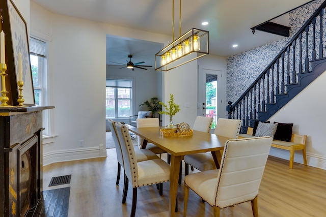 1017 Madison Ave, Columbus, OH 43205 - dining area with stairs, a ceiling fan, wood finished floors, recessed lighting, and a fireplace