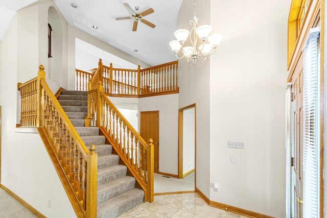 4775 Saint Andrews Dr, Westerville, OH 43082 - staircase with a ceiling fan, arched walkways, a towering ceiling, and a chandelier