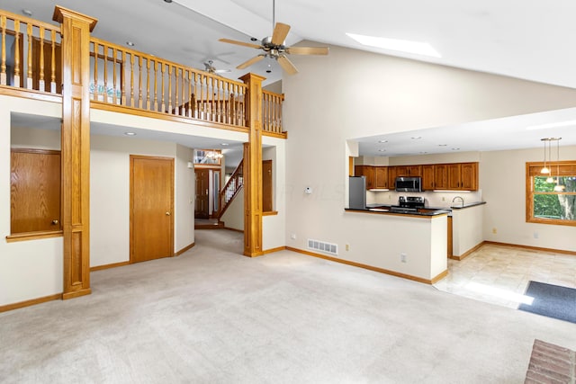 4775 Saint Andrews Dr, Westerville, OH 43082 - unfurnished living room featuring light carpet, stairs, a ceiling fan, and high vaulted ceiling