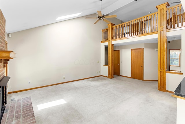 4775 Saint Andrews Dr, Westerville, OH 43082 - unfurnished living room featuring a fireplace, carpet flooring, ceiling fan, a skylight, and high vaulted ceiling