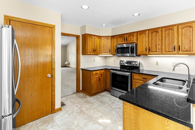 4775 Saint Andrews Dr, Westerville, OH 43082 - kitchen featuring stainless steel appliances, brown cabinetry, recessed lighting, dark stone counters, and light colored carpet