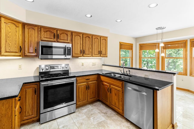 4775 Saint Andrews Dr, Westerville, OH 43082 - kitchen with stainless steel appliances, a peninsula, brown cabinets, recessed lighting, and dark countertops