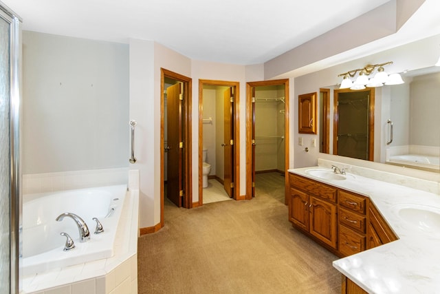 4775 Saint Andrews Dr, Westerville, OH 43082 - bathroom with double vanity, a garden tub, and a walk in closet