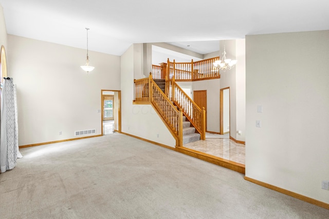4775 Saint Andrews Dr, Westerville, OH 43082 - unfurnished living room featuring high vaulted ceiling, carpet floors, stairway, and a chandelier