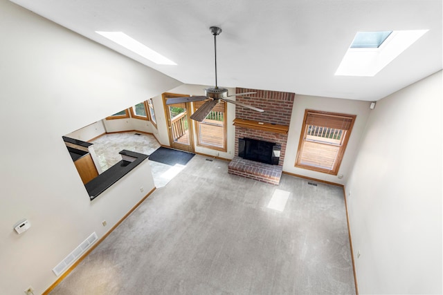 4775 Saint Andrews Dr, Westerville, OH 43082 - unfurnished living room with a skylight, a fireplace, vaulted ceiling, and ceiling fan