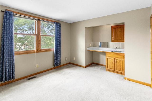 4775 Saint Andrews Dr, Westerville, OH 43082 - kitchen featuring light colored carpet, light countertops, and brown cabinetry