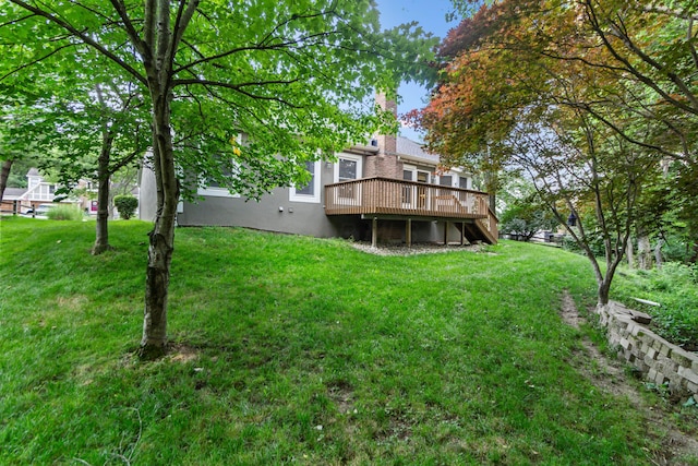 4775 Saint Andrews Dr, Westerville, OH 43082 - rear view of house with a wooden deck, a lawn, stucco siding, and a chimney