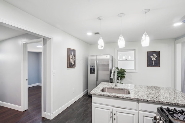 4425 Saint Ann Ln, Columbus, OH 43213 - kitchen with stainless steel appliances, light stone counters, white cabinetry, pendant lighting, and dark wood-type flooring