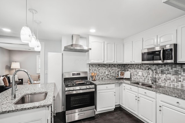 4425 Saint Ann Ln, Columbus, OH 43213 - kitchen featuring stainless steel appliances, wall chimney range hood, decorative backsplash, white cabinets, and light stone countertops